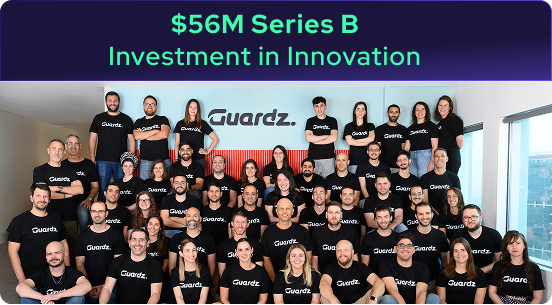 A large group of people wearing matching Guardz t-shirts pose together in an office. Above them, text reads $56M Series B Investment in Innovation for the 2025 Year in Review.